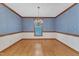 Spacious dining room with hardwood floors, blue wallpaper, and large window for natural light at 1133 Turner Farms Rd, Garner, NC 27529