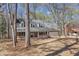 Exterior shot of brick home with mature trees, manicured landscaping, and porch at 1133 Turner Farms Rd, Garner, NC 27529