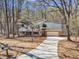 Exterior aerial showing home with mature trees, extended driveway, and meticulous landscaping at 1133 Turner Farms Rd, Garner, NC 27529