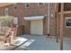 Side view of a brick home with two-car garage, door to the backyard, and manicured landscaping at 1133 Turner Farms Rd, Garner, NC 27529