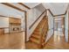 Inviting hallway with hardwood flooring showcases a staircase and access to the living room at 1133 Turner Farms Rd, Garner, NC 27529