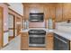 Kitchen featuring wood cabinets, stainless steel appliances, and a tile backsplash at 1133 Turner Farms Rd, Garner, NC 27529