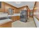 Spacious kitchen with stainless steel appliances and wood cabinets offers functionality and style at 1133 Turner Farms Rd, Garner, NC 27529