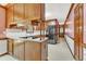 Kitchen showcasing wood cabinets, stainless steel appliances, and tile flooring at 1133 Turner Farms Rd, Garner, NC 27529