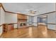 Cozy living room with brick fireplace, hardwood floors, and ceiling fan at 1133 Turner Farms Rd, Garner, NC 27529