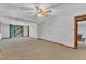 Bright living area with ceiling fan and sliding glass doors to a patio at 1133 Turner Farms Rd, Garner, NC 27529