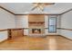 Bright living room with a brick fireplace, ceiling fan, and hardwood floors at 1133 Turner Farms Rd, Garner, NC 27529