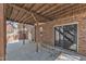 Covered brick patio featuring wood ceiling, concrete floors, and access to backyard with mature trees at 1133 Turner Farms Rd, Garner, NC 27529
