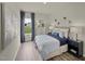 Cozy bedroom with soft bedding, stylish decor, and a large window offering a view of the outdoors at 1135 Winding Spring Dr, Mebane, NC 27302
