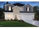 Charming two-story home with brick and siding, complemented by a well-manicured lawn and attractive landscaping at 1135 Winding Spring Dr, Mebane, NC 27302