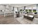 Open concept living space seamlessly integrating the kitchen, dining, and living room areas for modern living at 1135 Winding Spring Dr, Mebane, NC 27302