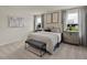 Spacious main bedroom with calming colors, two windows, decorative lighting, and an inviting bench at 1135 Winding Spring Dr, Mebane, NC 27302