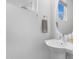 Modern half-bath with a floating sink, round mirror, and natural light, for a clean and functional space at 1208 Garner Rd, Raleigh, NC 27610