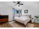 Bright bedroom featuring a ceiling fan, modern decor, and a large window at 1208 Garner Rd, Raleigh, NC 27610