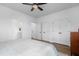 Spacious bedroom with hardwood floors, a ceiling fan, and ample closet space at 1208 Garner Rd, Raleigh, NC 27610