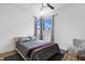 Bright bedroom featuring a ceiling fan and a large window at 1208 Garner Rd, Raleigh, NC 27610