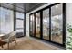 Inviting covered patio featuring large glass doors, comfortable seating, and an open view to the interior at 1208 Garner Rd, Raleigh, NC 27610