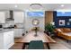 Modern dining room featuring a wooden table, pendant lighting, and seamless open-concept design to the kitchen at 1208 Garner Rd, Raleigh, NC 27610