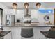 Modern kitchen island with stainless steel sink, sleek countertops, pendant lighting, and stylish bar stool seating at 1208 Garner Rd, Raleigh, NC 27610