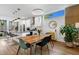 Bright, open kitchen with stainless steel appliances, white cabinets, island seating, and adjacent dining area at 1208 Garner Rd, Raleigh, NC 27610