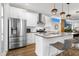 Modern kitchen featuring stainless steel appliances, white cabinets, a spacious island, and sleek countertops at 1208 Garner Rd, Raleigh, NC 27610