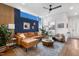 Bright living room features a ceiling fan, a comfortable leather sofa, and modern decor at 1208 Garner Rd, Raleigh, NC 27610