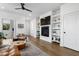 Inviting living room features built-in shelves, fireplace, and modern ceiling fan at 1208 Garner Rd, Raleigh, NC 27610