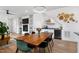Open-concept living space features a modern dining table and a comfortable seating area at 1208 Garner Rd, Raleigh, NC 27610