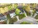 An aerial view shows a home with verdant yard with lovely landscaping and mature shade trees at 1210 Ventura Springs Ct, Wake Forest, NC 27587