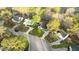 An aerial view shows the lovely home with a well maintained lawn, landscaping and mature trees at 1210 Ventura Springs Ct, Wake Forest, NC 27587