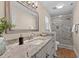 This bathroom features granite countertops, tiled floors, and a walk-in shower at 1210 Ventura Springs Ct, Wake Forest, NC 27587