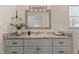 This bathroom has a granite countertop with a silver-trimmed mirror above at 1210 Ventura Springs Ct, Wake Forest, NC 27587