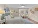 This bedroom features hard wood floors, a window nook, and stylish decor at 1210 Ventura Springs Ct, Wake Forest, NC 27587