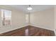 This bedroom features wood floors, natural light, and a modern ceiling fan at 1210 Ventura Springs Ct, Wake Forest, NC 27587