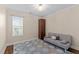 Cozy bedroom with neutral walls, natural light, and a comfortable couch at 1210 Ventura Springs Ct, Wake Forest, NC 27587
