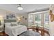 Bedroom features hardwood floors, large windows, and a decorative ceiling fan at 1210 Ventura Springs Ct, Wake Forest, NC 27587