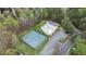 Aerial shot of a community pool, tennis courts, clubhouse, and parking in a wooded setting at 1210 Ventura Springs Ct, Wake Forest, NC 27587