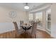 Bright dining room featuring a glass table, wainscoting and a bay window at 1210 Ventura Springs Ct, Wake Forest, NC 27587