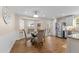 Bright dining room featuring bay window, chandelier and stainless refrigerator at 1210 Ventura Springs Ct, Wake Forest, NC 27587