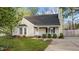 Charming single-story home with a cozy front porch and well-maintained landscaping at 1210 Ventura Springs Ct, Wake Forest, NC 27587