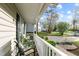 Relaxing front porch seating area with a view of the lovely neighborhood at 1210 Ventura Springs Ct, Wake Forest, NC 27587