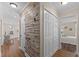 Hallway with white trim, wood-look floors, and closet space at 1210 Ventura Springs Ct, Wake Forest, NC 27587