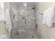The marble shower has a glass door, built-in shelving, and a towel bar at 1210 Ventura Springs Ct, Wake Forest, NC 27587