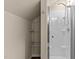 An enclosed shower and a shelving unit providing organization and relaxation at 1210 Ventura Springs Ct, Wake Forest, NC 27587