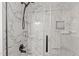 The shower features marble walls and a sleek black shower head and handle at 1210 Ventura Springs Ct, Wake Forest, NC 27587