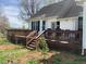 A spacious two-level wooden deck with outdoor seating and stairs leading to the landscaped backyard at 126 W Quail Ridge Rd, Oxford, NC 27565