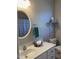 Bathroom featuring a sleek vanity, an oval mirror, and modern fixtures at 126 W Quail Ridge Rd, Oxford, NC 27565