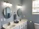 Well-lit bathroom featuring double vanity sinks and modern fixtures at 126 W Quail Ridge Rd, Oxford, NC 27565