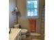 Bathroom featuring a sleek vanity, a window, and modern fixtures at 126 W Quail Ridge Rd, Oxford, NC 27565