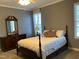 Comfortable bedroom featuring a full bed, dresser, and a window at 126 W Quail Ridge Rd, Oxford, NC 27565